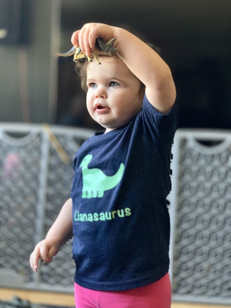 girl with dinosaur toy
