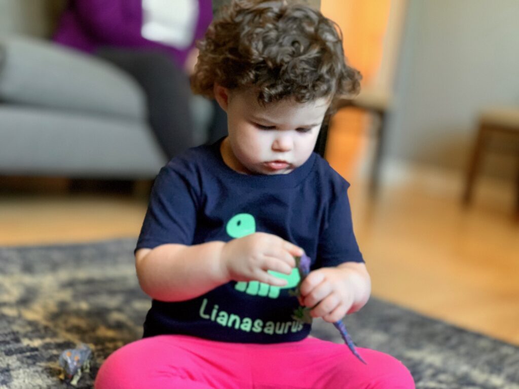little girl with dinosaur